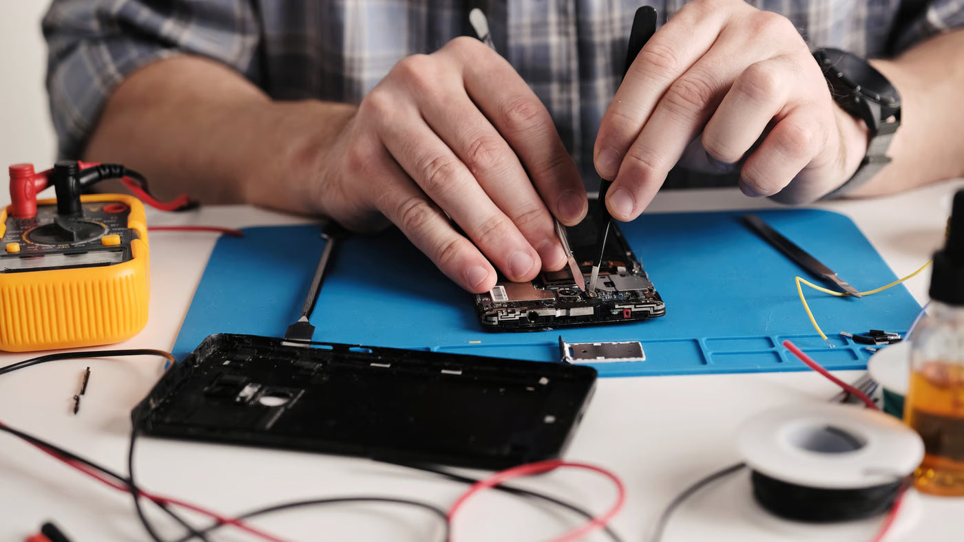 Technician inspecting a refurbished device